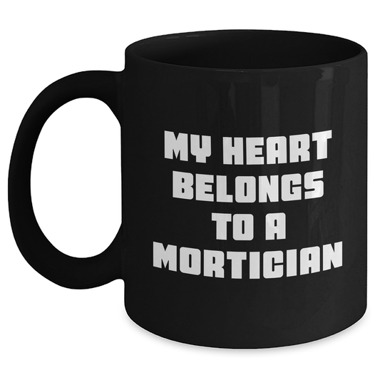 Mortician Gifts from Men, Funny Quote My Heart Belongs To A Mortician on Black Coffee Mug for Mother's Day, Mortician Unique Gifts - Main